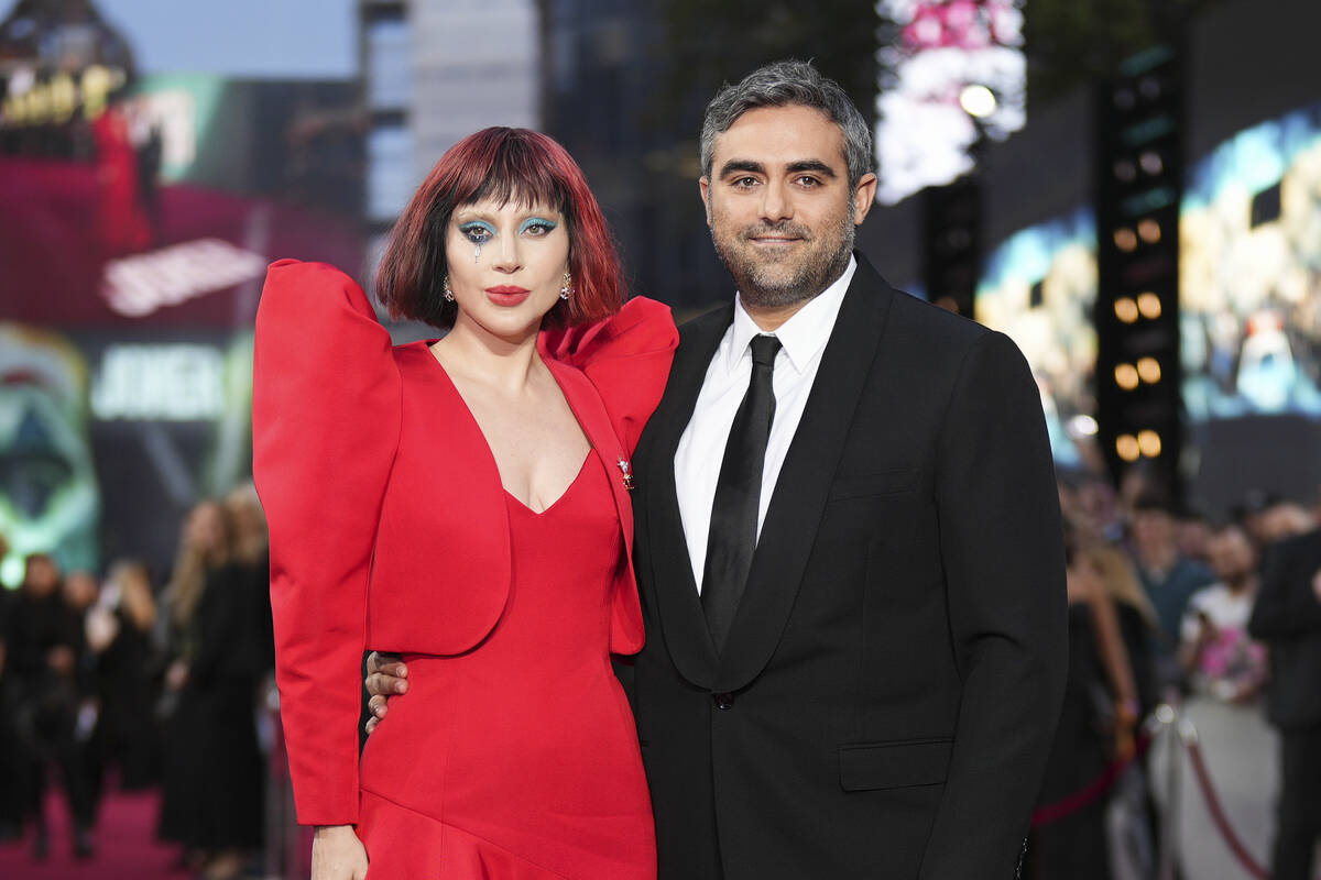 Lady Gaga, left, and Michael Polansky pose for photographers upon arrival at the premiere for t ...