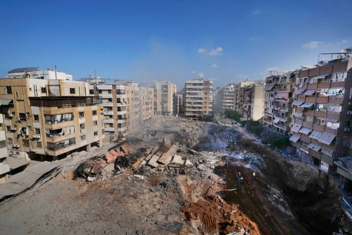 People gather at the site of the assassination of Hezbollah leader Hassan Nasrallah in Beirut's ...