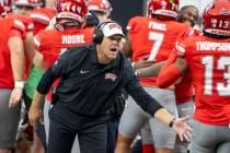 UNLV head coach Barry Odom welcomes players back to the sideline after scoring a touchdown duri ...