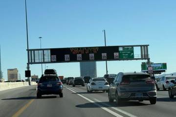 Motorists travel near one of the many active traffic management signs that help traffic move sm ...