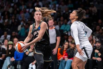 New York Liberty guard Sabrina Ionescu, left, is defended by Las Vegas Aces forward Alysha Clar ...