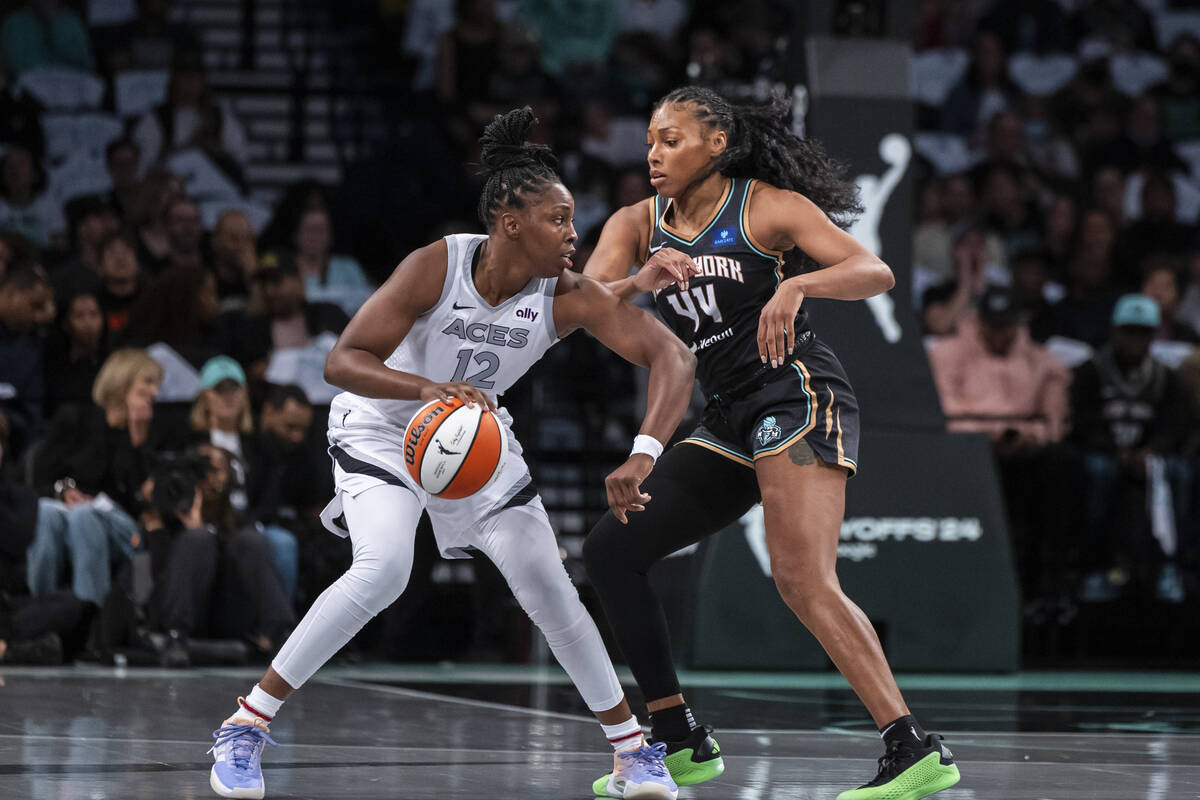 Las Vegas Aces guard Chelsea Gray (12) is defended by New York Liberty forward Betnijah Laney-H ...