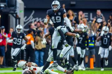 Raiders defensive end Charles Snowden (49) leaps in celebration after a sack of Cleveland Brown ...