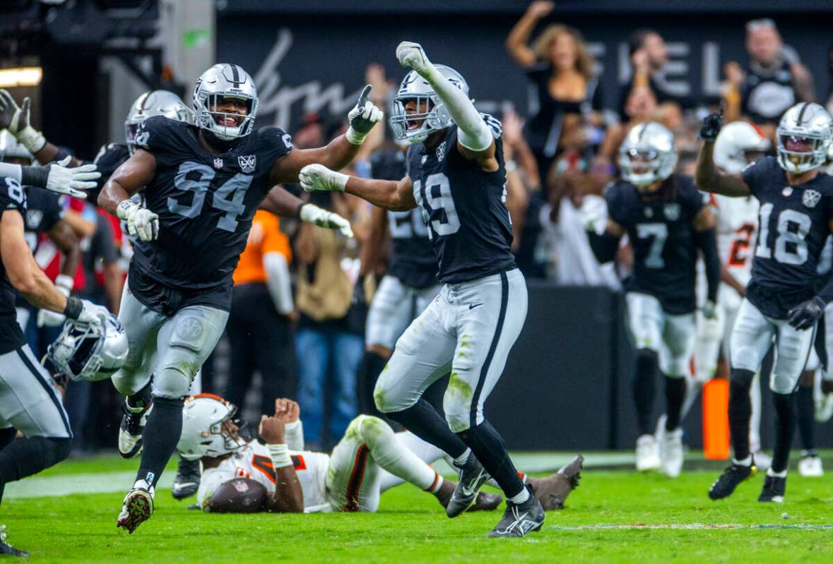 Raiders defensive end Charles Snowden (49) and defensive tackle Christian Wilkins (94) celebrat ...