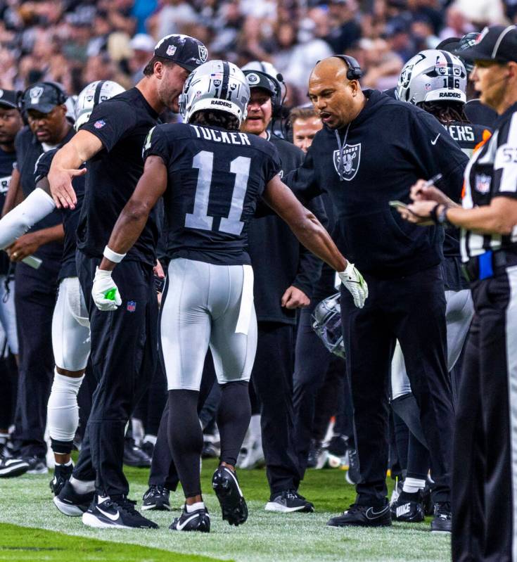 Raiders wide receiver Tre Tucker (11) is congratulated on a score by Head Coach Antonio Pierce ...