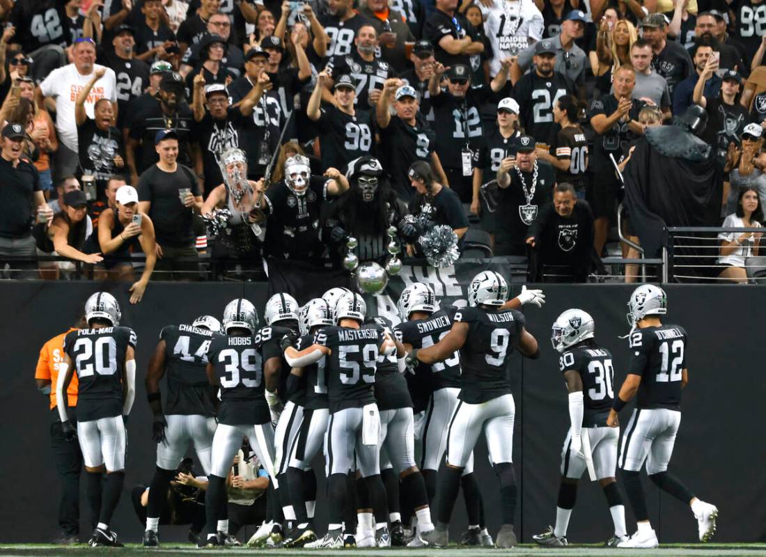 Raiders players celebrate after safety Tre'von Moehrig (7) intercepted the ball during the seco ...