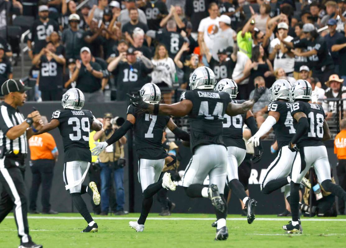 Raiders players celebrate after safety Tre'von Moehrig (7) intercepted the ball during the seco ...