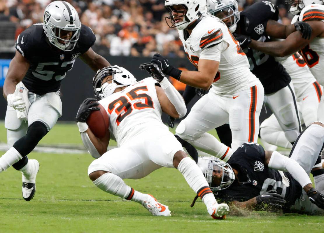 The Cleveland Browns running back Gary Brightwell (35) is tripped by Raiders running back Ameer ...