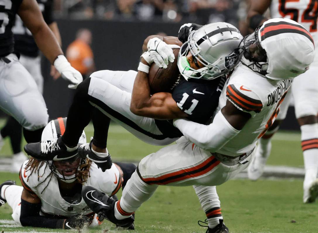 The Cleveland Browns linebacker Jeremiah Owusu-Koramoah (6) takes down Raiders wide receiver Tr ...