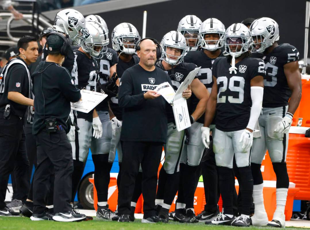 Raiders special teams coordinator Tom McMahon prepares to review his playbook with players from ...