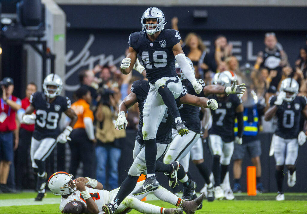 Raiders defensive end Charles Snowden (49) leaps in celebration after a sack of Cleveland Brown ...