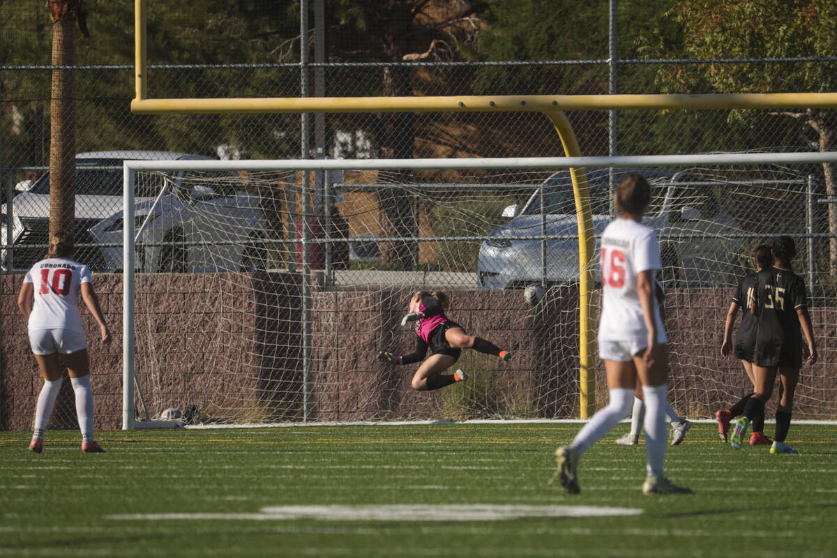 Coronado's Ryan Neel (10) scores a goal against Faith Lutheran goalkeeper Olivia Petty during a ...