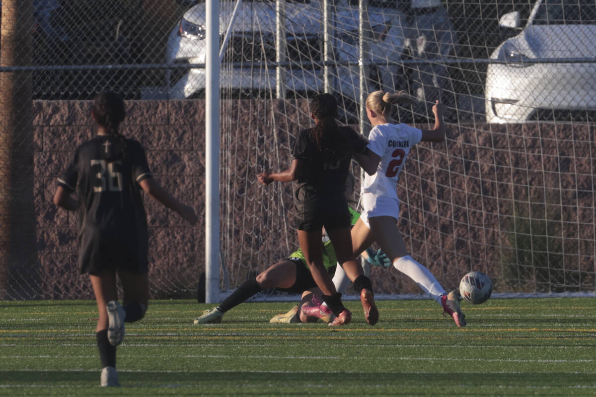 Faith Lutheran's Briana Lee (10) kicks the ball in past Coronado's midfielder Emily McKinney (2 ...