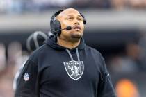 Raiders head coach Antonio Pierce looks to a replay screen during the first half of an NFL game ...