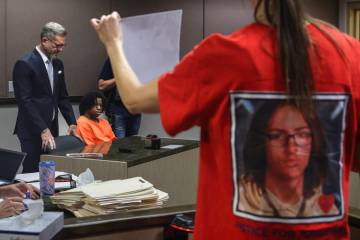 Mellisa Ready holds a photo of her son Jonathan Lewis as she makes a statement to the court dur ...