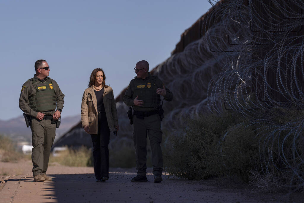 Democratic presidential nominee Vice President Kamala Harris, center, talks with John Modlin, t ...