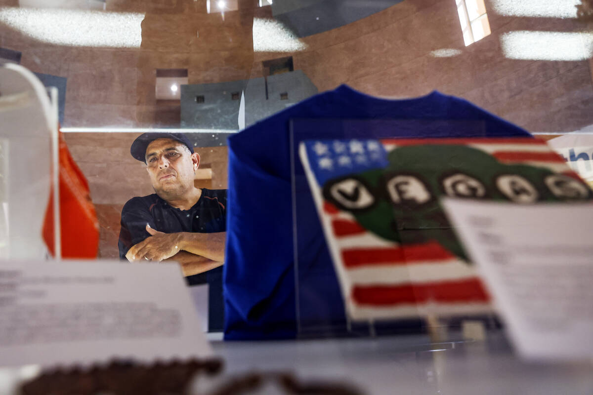 Jose Gomez looks at mementos on display at the “Remembering 1 October” exhibit in ...