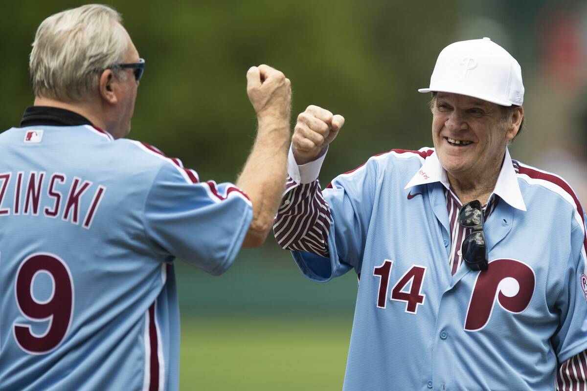 Greg Luzinski fist bumps with Pete Rose during the ceremony honoring the 1980 Phillies. (Jose ...