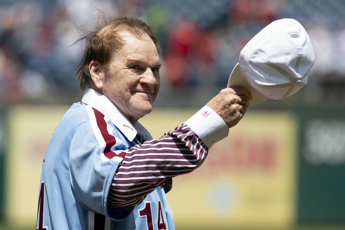 Pete Rose acknowledges fans during a ceremony honoring the 1980 Phillies World Series team at C ...