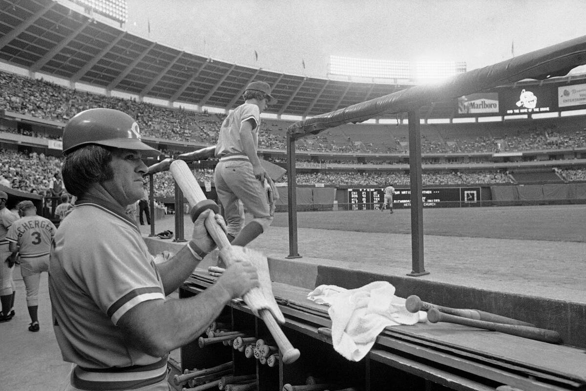 Cincinnati Reds Pete Rose prepares his bat handle before leading off against the Atlanta Braves ...