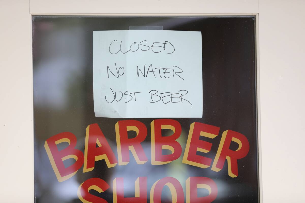 A sign hangs outside a closed barber shop and bar in Asheville, N.C., Monday, Sept. 30, 2024. ( ...