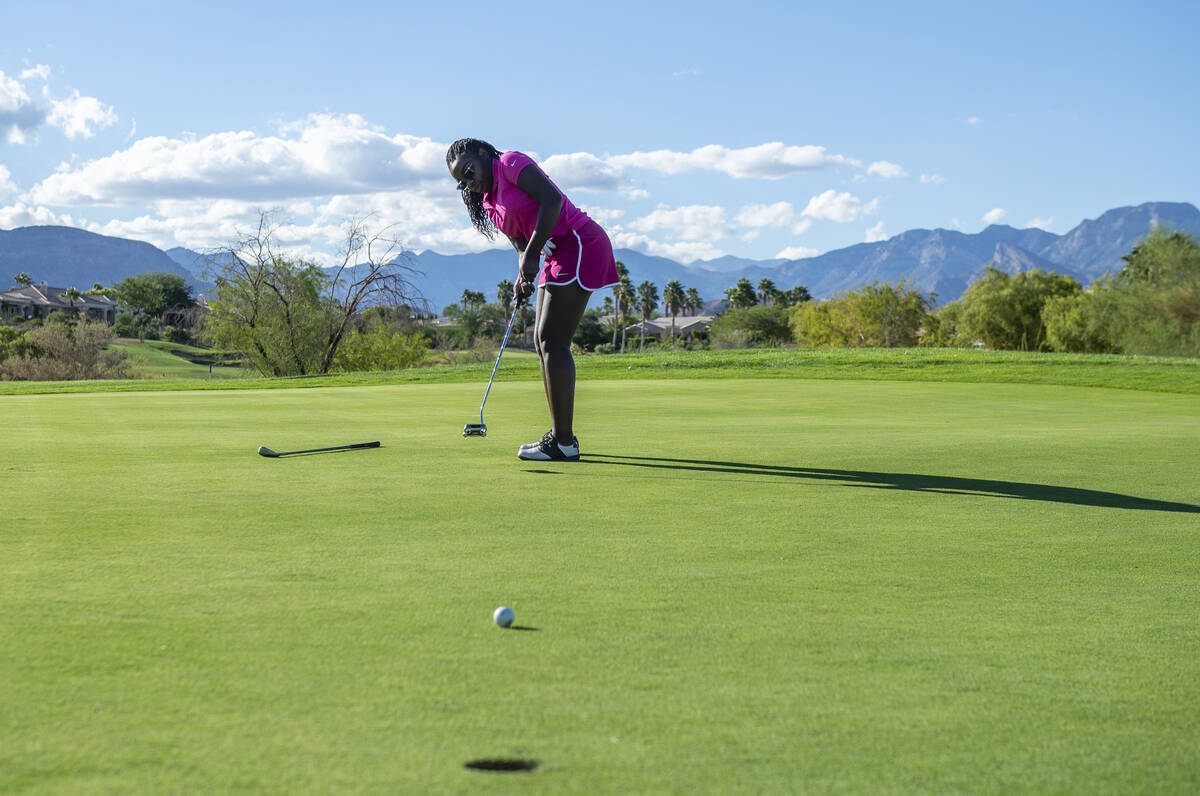 Faith Lutheran High School golfer Faith McKinney putts from the 13th hole during practice at th ...