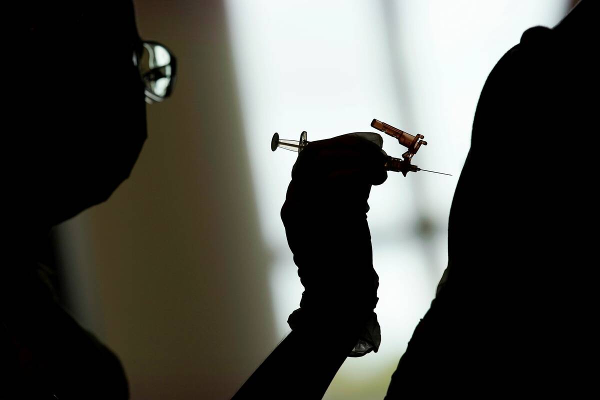 A nursing student administers the Moderna COVID-19 vaccine at a vaccination center at UNLV in L ...