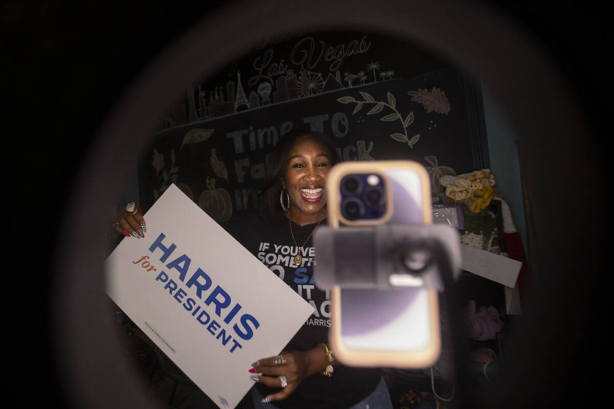 Shaunda Necole records herself during a canvassing and phone banking event for the Democratic p ...