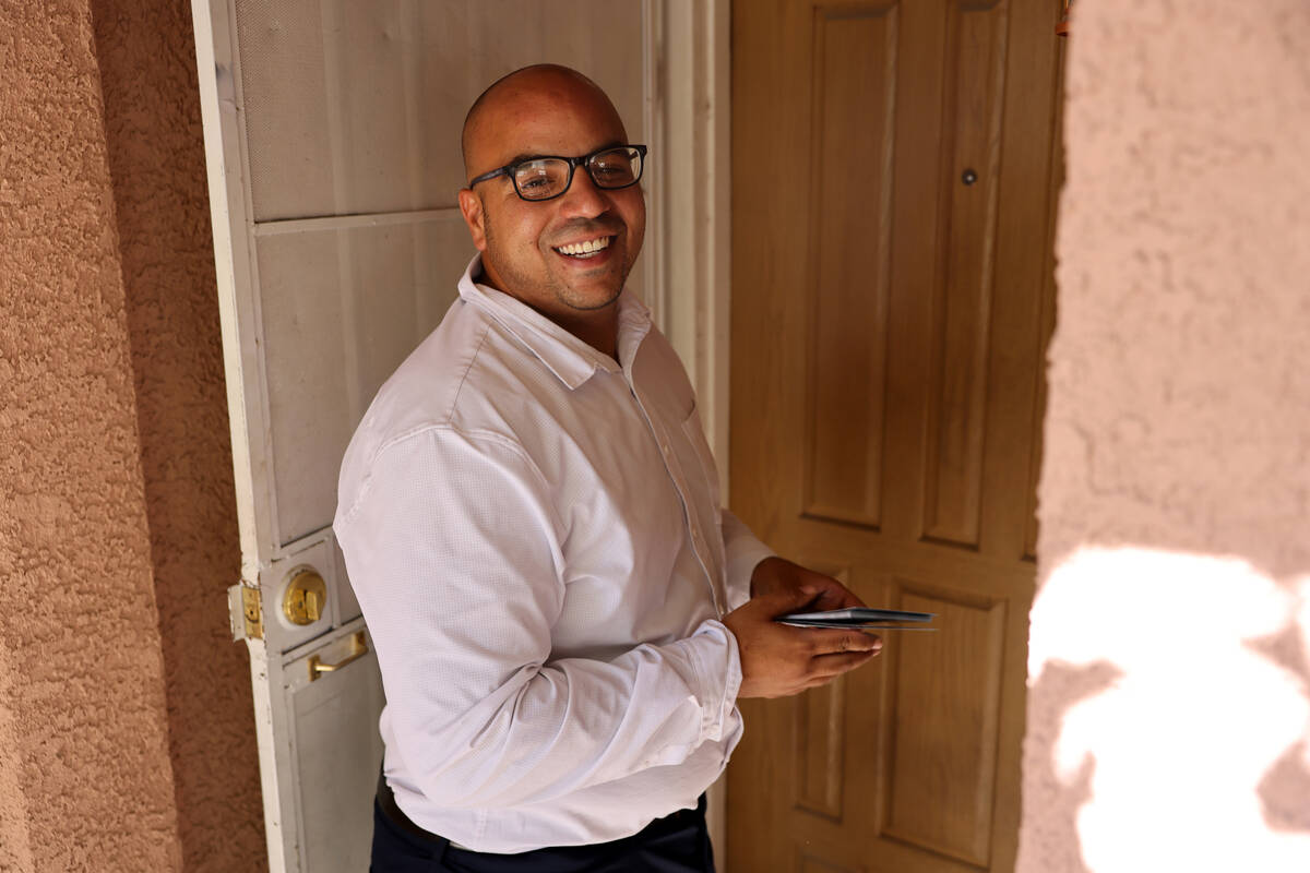 Jovan Jackson, a candidate for Nevada Assembly District 6, knocks on a door while canvassing in ...