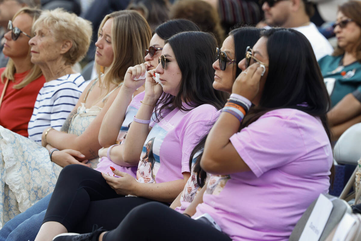 Family members of the Oct. 1 shooting victim Christiana Duarte, right to left wearing purple T- ...