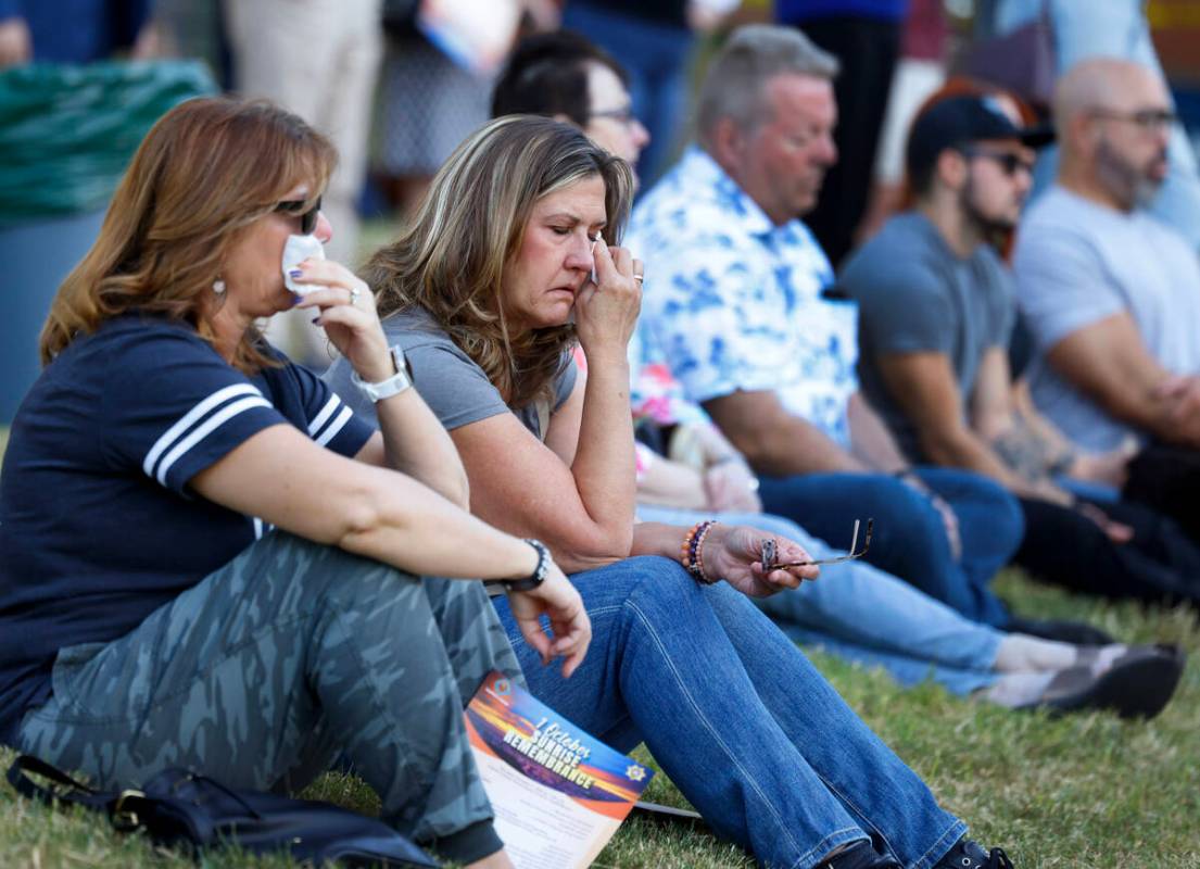 Angela Arriola, left, and Kathleen Spain weep as they attend the 1 October Sunrise Remembrance ...