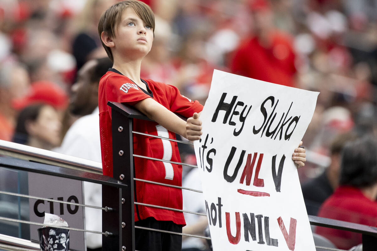 A young UNLV fan holds a sign before the college football game against Fresno State at Allegian ...