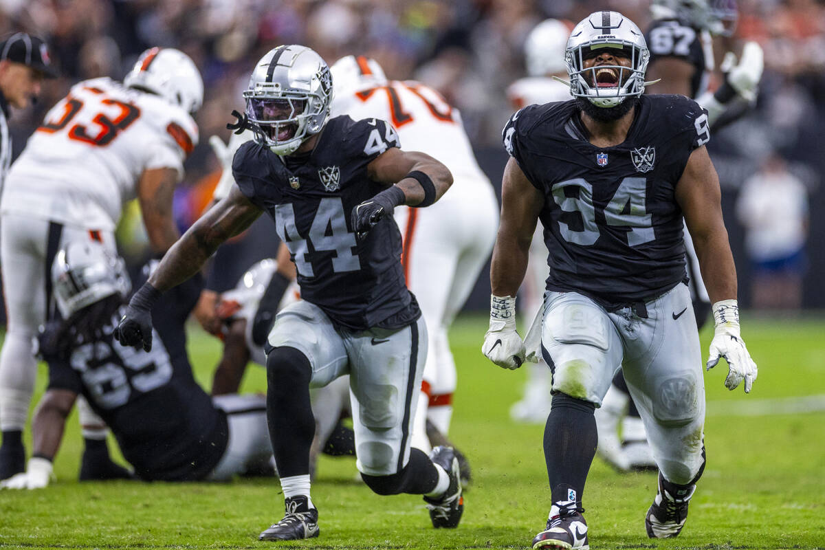 Raiders defensive end K'Lavon Chaisson (44) and defensive tackle Christian Wilkins (94) celebra ...