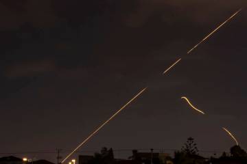 An Israeli air defense system fires to intercept missiles over Hadera, Israel, Tuesday, Oct. 1, ...