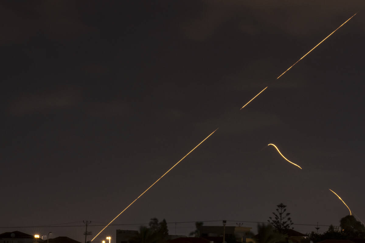 An Israeli air defense system fires to intercept missiles over Hadera, Israel, Tuesday, Oct. 1, ...