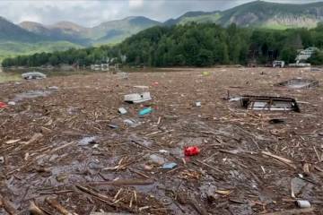 Flood debris from Hurricane Helene floats by in Rutherford County, N.C., Sunday, Sept. 29, 2024 ...