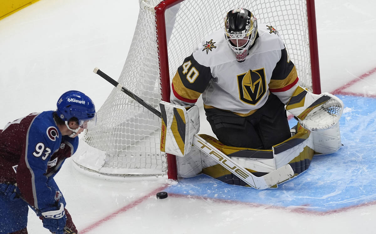 Vegas Golden Knights goalie Akira Schmid, right, stops a shot by Colorado Avalanche center Jean ...