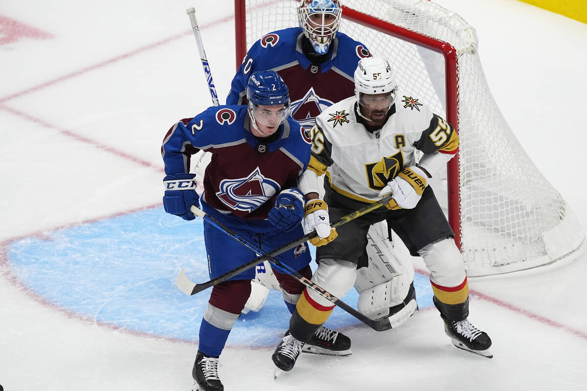 Vegas Golden Knights right wing Keegan Kolesar, right, jostles for position in front of the net ...