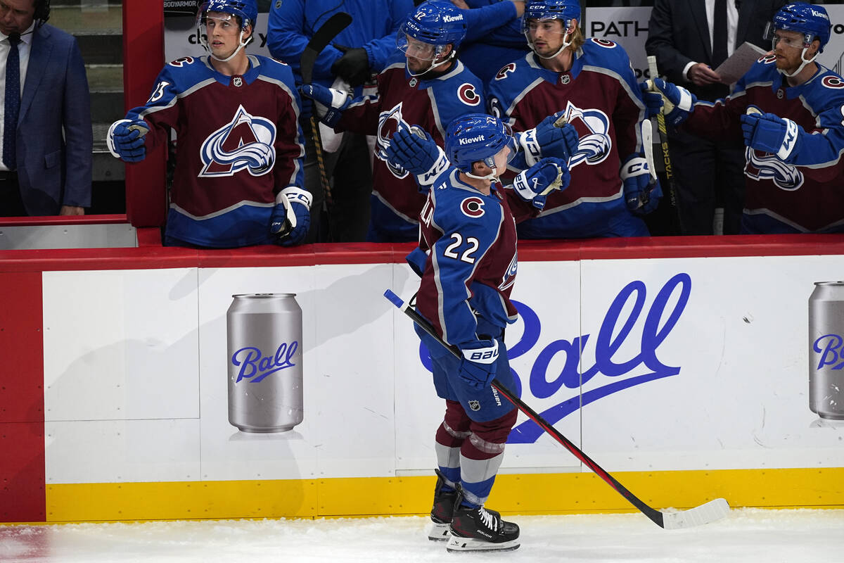 Colorado Avalanche left wing Jere Innala, front, is congratulated as he passes the team box aft ...