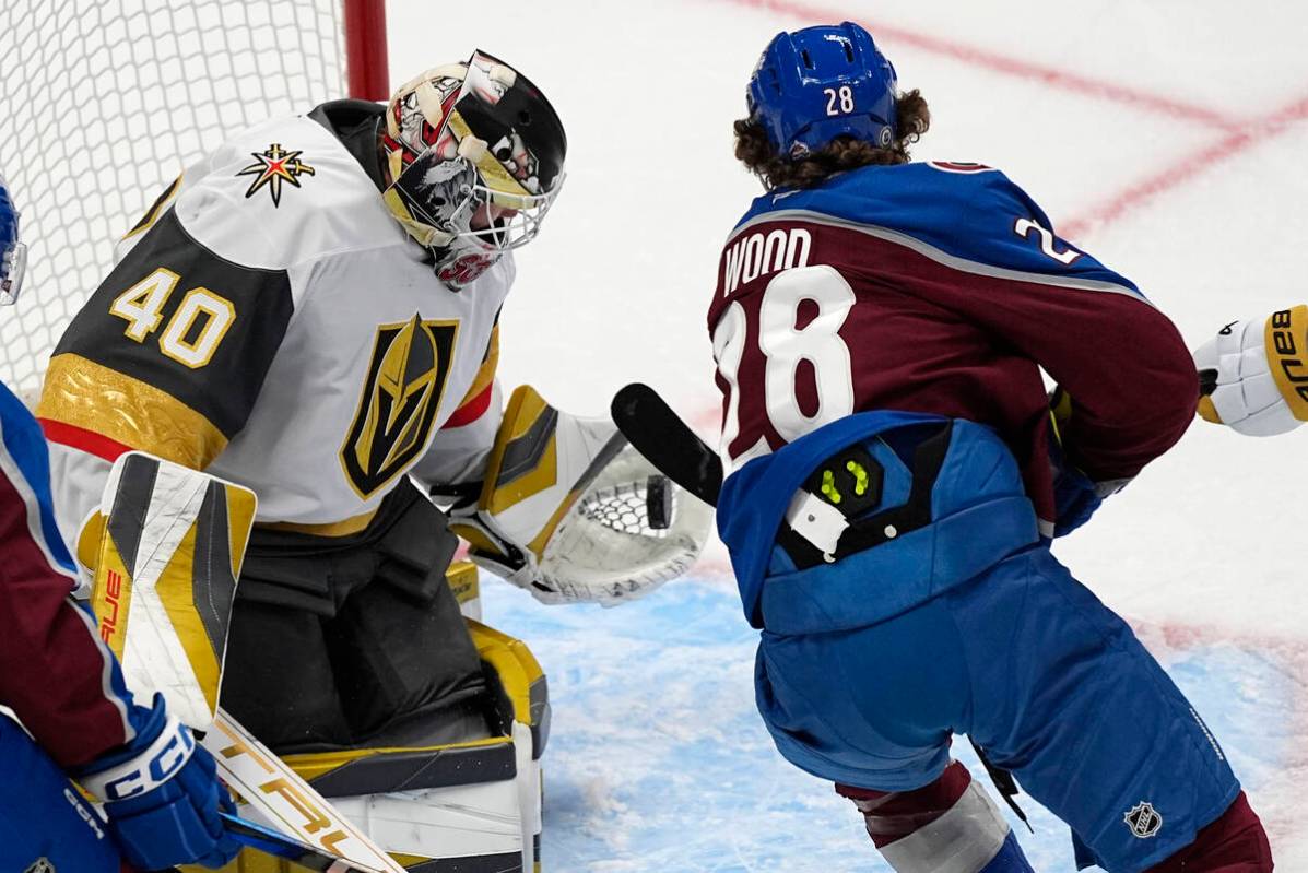 Vegas Golden Knights goalie Akira Schmid, left, makes a glove save of a shot from Colorado Aval ...