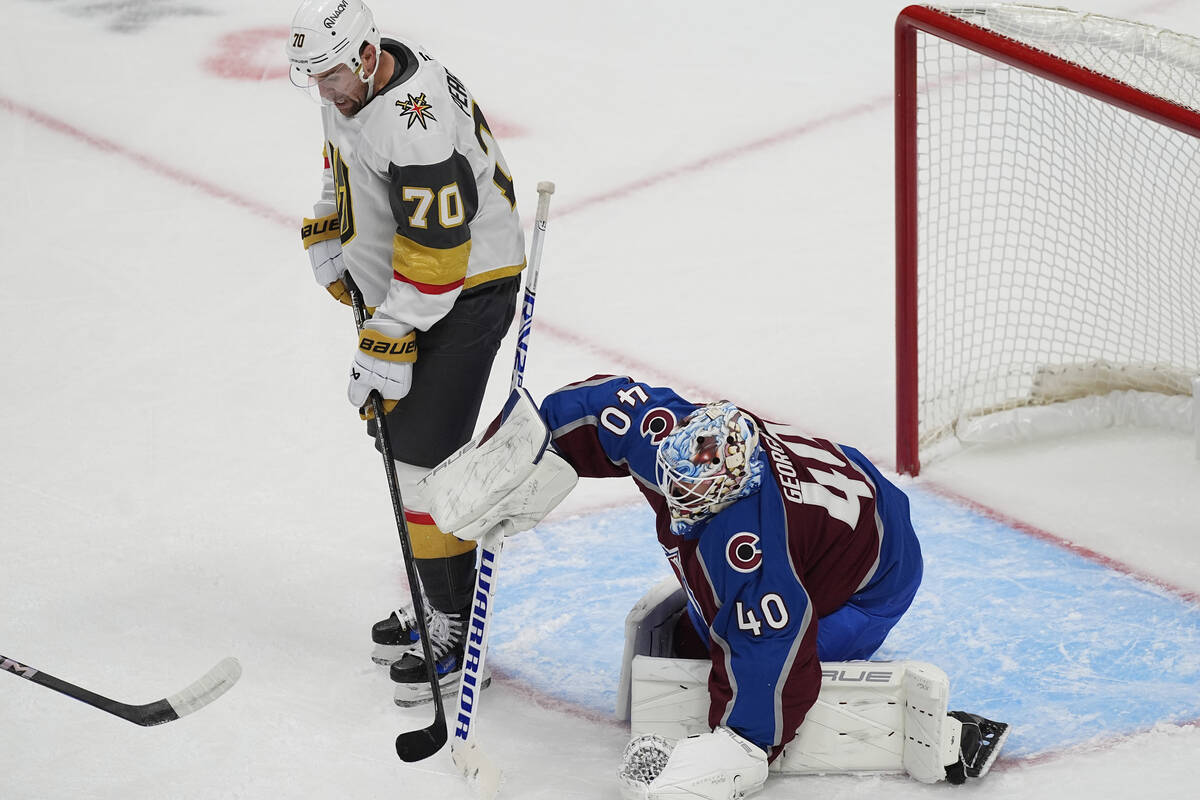 Vegas Golden Knights winger Tanner Pearson, left, redirects the puck past Colorado Avalanche go ...