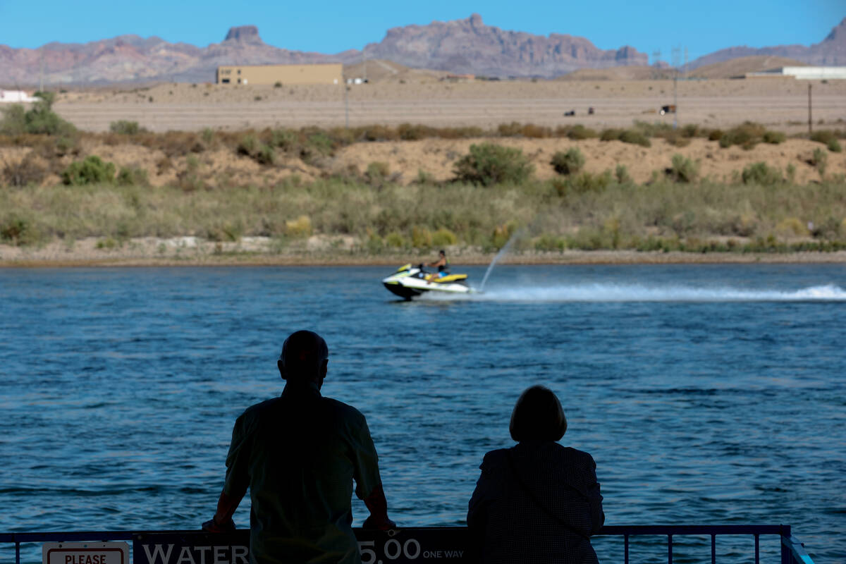 People waiting for the water taxi look out onto the Colorado River on Tuesday, Sept. 17, 2024, ...