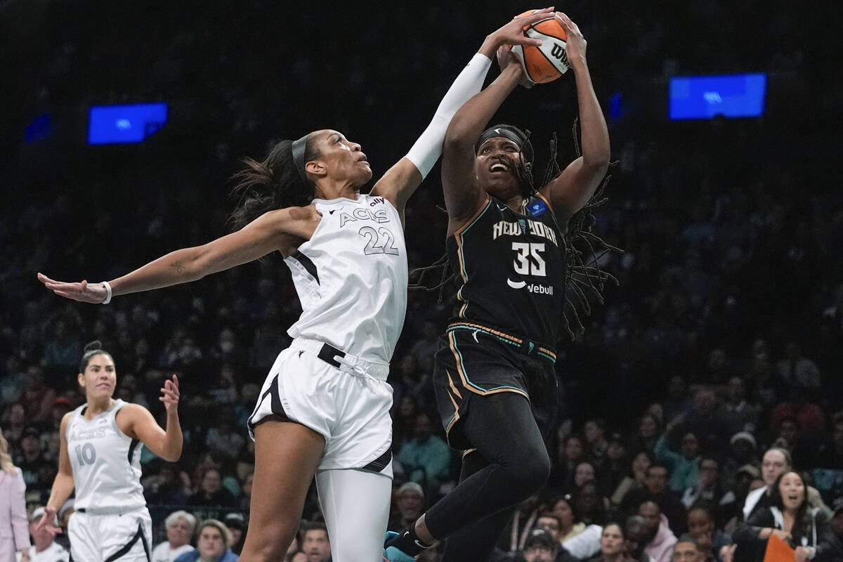 Las Vegas Aces' A'ja Wilson (22) defends a shot by New York Liberty's Jonquel Jones (35) during ...