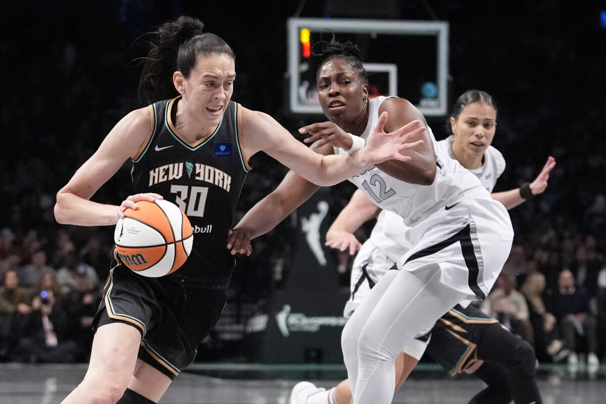 New York Liberty's Breanna Stewart (30) drives past Las Vegas Aces' Chelsea Gray (12) during th ...