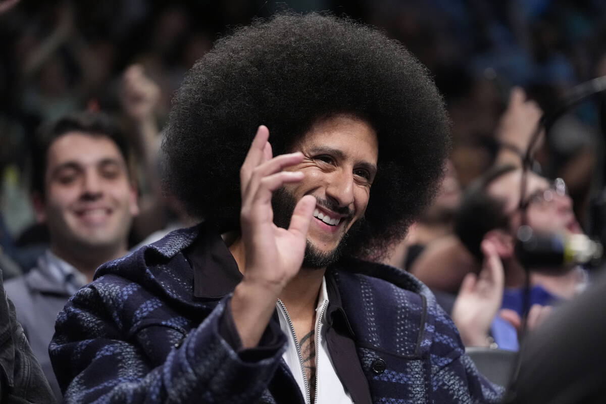 Colin Kaepernick gestures to fans during the second half of a WNBA basketball semifinal game be ...