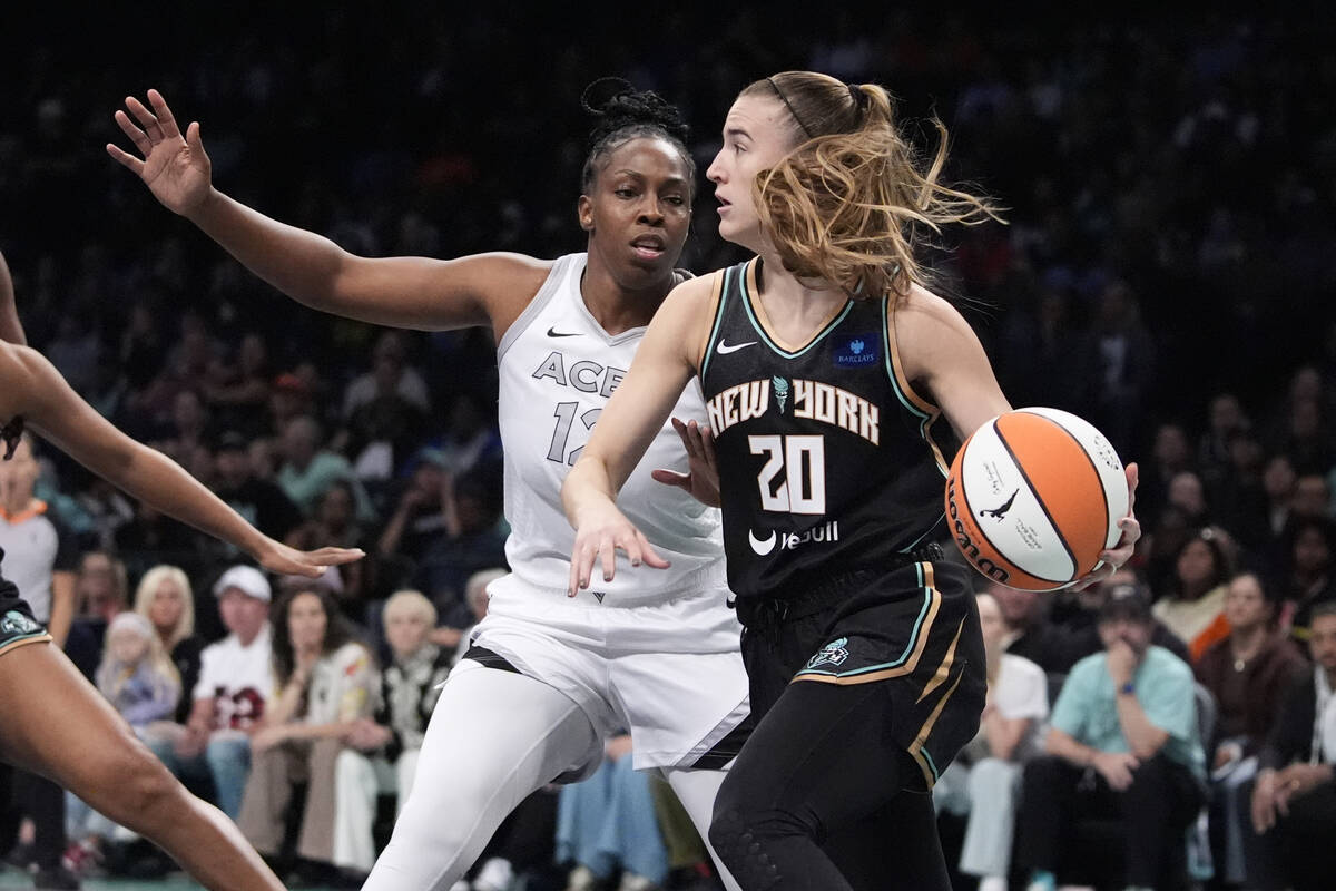 New York Liberty's Sabrina Ionescu (20) passes way from Las Vegas Aces' Chelsea Gray (12) durin ...