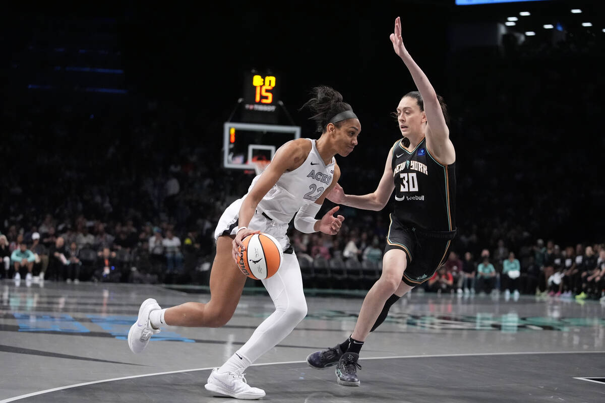 New York Liberty's Breanna Stewart (30) defends Las Vegas Aces' A'ja Wilson (22) during the sec ...