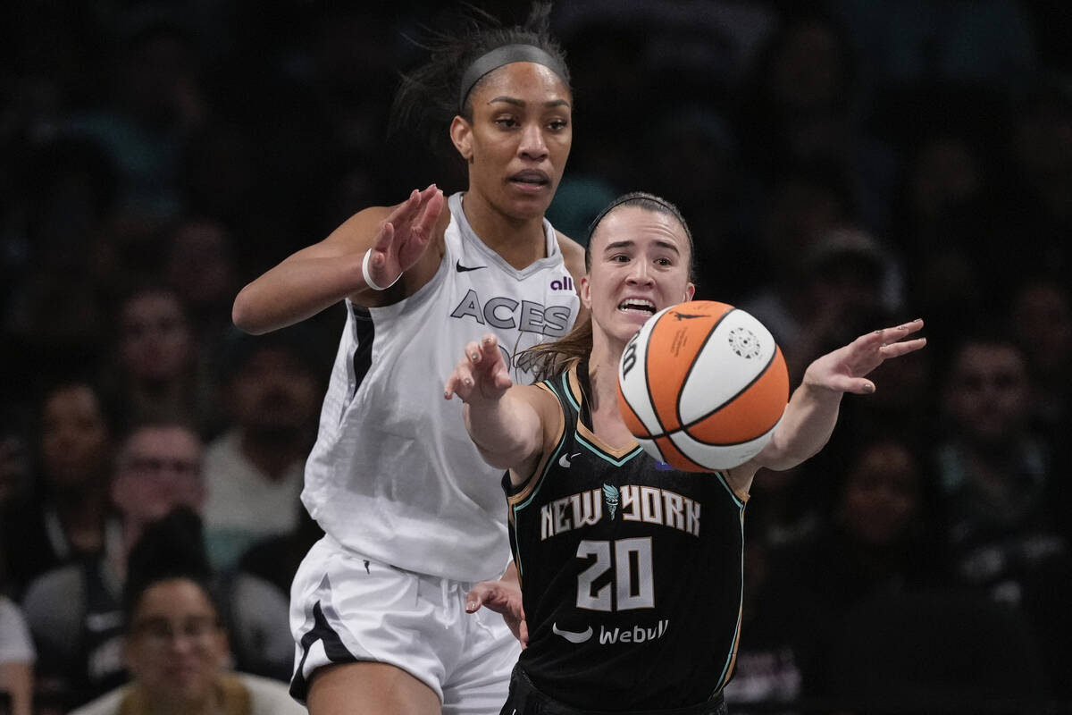 New York Liberty's Sabrina Ionescu (20) passes away from Las Vegas Aces' A'ja Wilson (22) durin ...