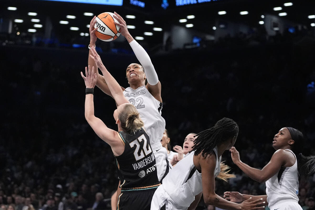 Las Vegas Aces' A'ja Wilson (22) fights for control of the ball with New York Liberty's Courtne ...