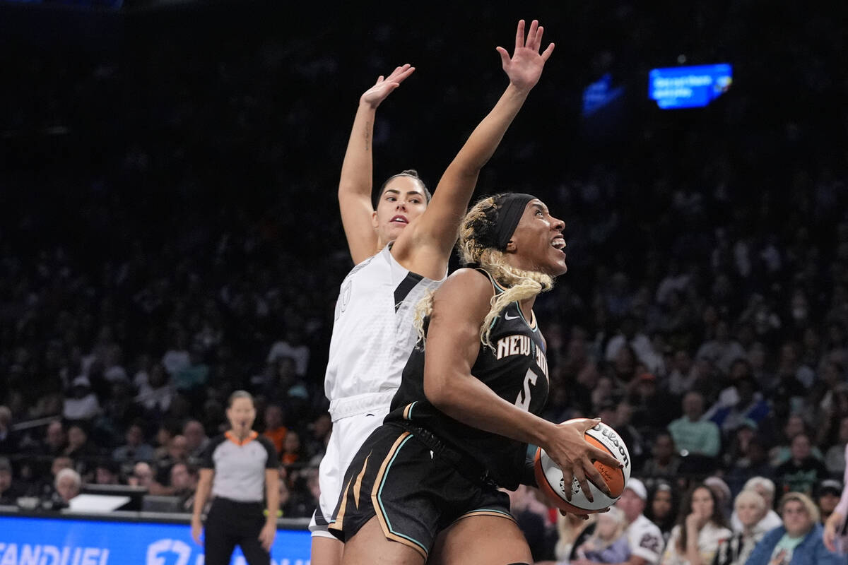 New York Liberty's Kayla Thornton (5) drives past Las Vegas Aces' Kelsey Plum (10) during the f ...